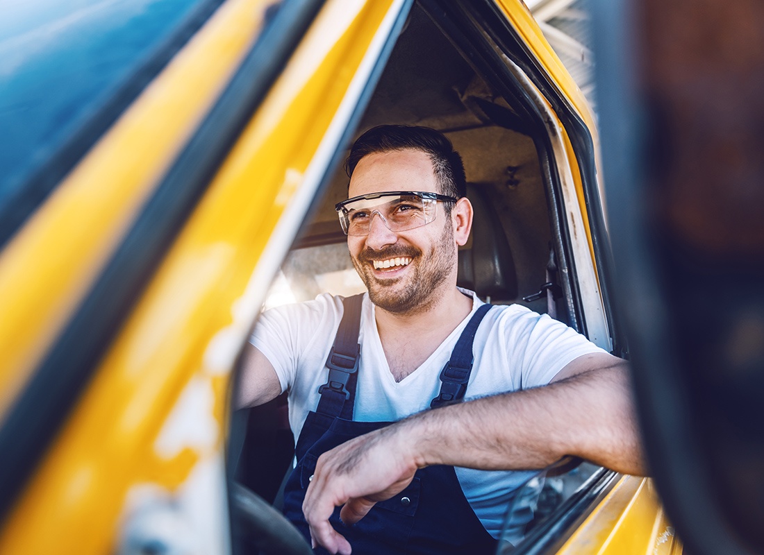 Business Insurance - Cheerful Worker Driving His Van