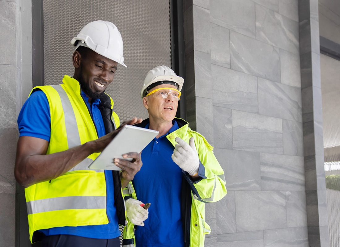 Read Our Reviews - Contractor Looking at a Tablet